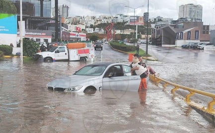 Rescatan a mujer en brazos tras quedar atrapada en su vehículo por las lluvias en San Luis Potosí 