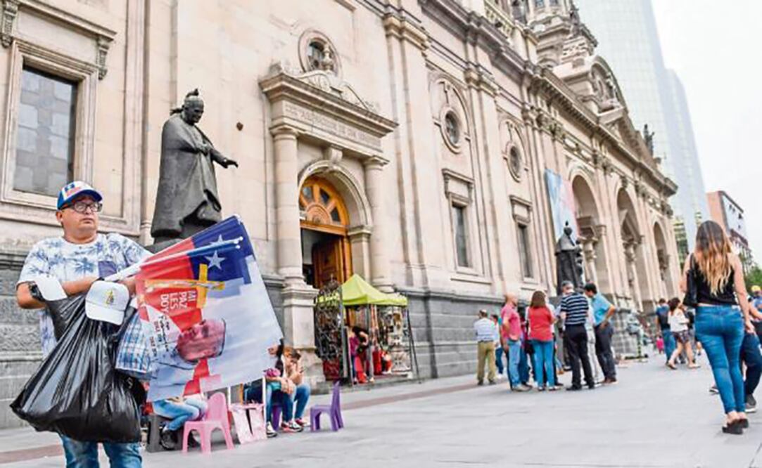 Un vendedor ofrece en Santiago de Chile mercancía relacionada con la visita del Papa, que iniciará la noche de mañana. (MARTIN BERNETTI. AFP)